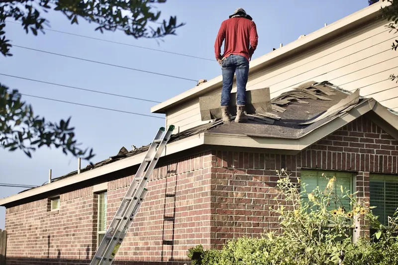 Professional roofer working on a residential roof in Westwood Heights
